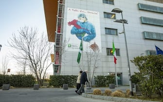 A mural of a drawing by illustrator Alessandro Adelio Rossi, with the inscription "Thank you all" near an entrance to the Papa Giovanni XXIII hospital, in Bergamo, the original epicenter of the coronavirus pandemic in Europe, Italy, on Monday Feb. 21, 2022. Masks are gone in most places, and vacation season is in full swing asÂ workers rushÂ for the beaches and cities they missed in the two years marked by the pandemic.Â Photographer: Francesca Volpi/Bloomberg via Getty Images