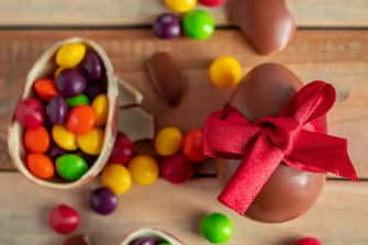 Close up easter sweets - chocolate eggs and sweets on a brown background.