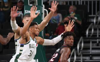 MILWAUKEE, WI - MAY 24: Giannis Antetokounmpo #34 of the Milwaukee Bucks plays defense on Jimmy Butler #22 of the Miami Heat during Round 1, Game 2 of the 2021 NBA Playoffs on May 24, 2021 at the Fiserv Forum Center in Milwaukee, Wisconsin. NOTE TO USER: User expressly acknowledges and agrees that, by downloading and or using this Photograph, user is consenting to the terms and conditions of the Getty Images License Agreement. Mandatory Copyright Notice: Copyright 2021 NBAE (Photo by Gary Dineen/NBAE via Getty Images).