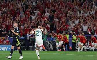 epa11433247 Kevin Csoboth (2L) of Hungary celebrates scoring the opening goal during the UEFA EURO 2024 Group A soccer match between Scotland and Hungary, in Stuttgart, Germany, 23 June 2024.  EPA/MOHAMED MESSARA