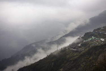 A road winds through the mountains near the Nathula Pass, an open trading post in the Himalayas between India and China, in Sikkim, India, on Wednesday, May 4, 2016. The Nathula Pass, once part of the ancient Silk Road and later sealed after a 1962 war, was reopened in 2006 as a symbol of improved relations between Asian neighbors that account for more than a third of the world's population. A decade later, however, it perhaps better reflects a trust deficit: the pass even does not account for one percent of overall bilateral commerce. Photographer: Prashanth Vishwanathan/Bloomberg via Getty Images