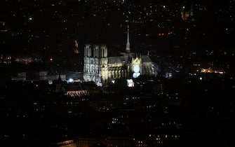 This photograph shows Notre-Dame Cathedral illuminated ahead of a ceremony to mark the re-opening of the landmark Cathedral, in central Paris, on December 7, 2024. Around 50 heads of state and government are expected in the French capital to attend the ceremony marking the rebuilding of the Gothic masterpiece five years after the 2019 fire which ravaged the world heritage landmark and toppled its spire. Some 250 companies and hundreds of experts were part of the five-year restoration project at a cost of hundreds of millions of euros. (Photo by Gregoire CAMPIONE / AFP)