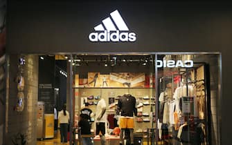 SHANGHAI, CHINA - OCTOBER 22, 2023 - Customers pass an Adidas advertisement featuring Lionel Messi at the Adidas flagship store in Shanghai, China, October 22, 2023. (Photo credit should read CFOTO/Future Publishing via Getty Images)