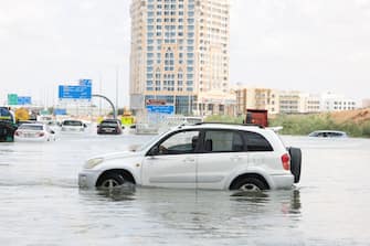A driver attempts to drive through flood water on a flooded highway after a rainstorm in Dubai, United Arab Emirates, on Wednesday, April 17, 2024. The United Arab Emirates experienced its heaviest downpour since records began in 1949, Dubai's media office said in a statement. Photographer: Christopher Pike/Bloomberg via Getty Images