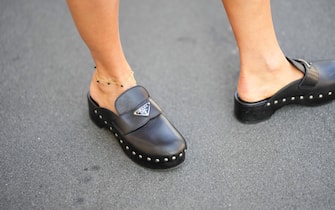 MILAN, ITALY - SEPTEMBER 22: Maja Malnar wears black shiny leather mules from Prada, outside Prada, during the Milan Fashion Week - Womenswear Spring/Summer 2023 on September 22, 2022 in Milan, Italy. (Photo by Edward Berthelot/Getty Images)