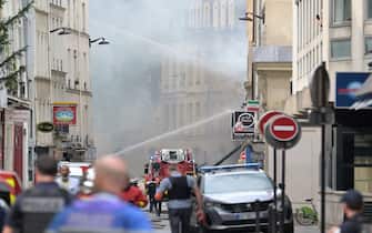 French firefighters put out a fire after a building partly collapsed at Place Alphonse-Laveran in the 5th arrondissement of Paris, on June 21, 2023. A major fire broke out on June 21, 2023 in a building in central Paris, part of which collapsed, according to images taken by AFP journalists. (Photo by Alain JOCARD / AFP) (Photo by ALAIN JOCARD/AFP via Getty Images)