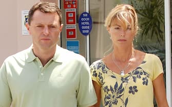 Gerry and wife Kate, parents of missing four-year-old Briton Madeleine McCann, walk out of a hotel for a press interview in Praia da Luz, in southern Portugal 09 August 2007. Portuguese and British newspapers report that during a review of evidence sniffer dogs from the British police found traces of blood and the odor of a corpse inside the room from which Maddie went missing in May. Madeleine McCann by this weekend will have been missing for 100 days from a hotel room in the southern Portuguese resort where she and her two-year-old twin siblings were sleeping while her parents were dining at a nearby restaurant. AFP PHOTO / POOL/ STEVE PASRONS (Photo credit should read Steve Parsons/AFP via Getty Images)