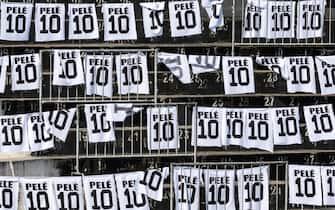 epa10386766 Posters with the number 10 of Pele are displayed in the stands during a wake for late soccer legend Pele at the Vila Belmiro stadium, in Santos, Brazil, 02 January 2023. The wake for Pele, who died at the age of 82, began for Brazilian fans to pay tribute to the legendary striker, considered by many to be the best footballer in history.  EPA/ANTONIO LACERDA