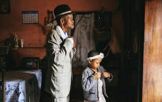 Dada Paul Rakotazandriny (91), who is living with dementia, and his granddaughter, Odliatemix Rafaraniriana (5), get ready for church on Sunday morning at his home in Antananarivo, Madagascar. 12 March 2023