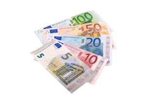 Euro banknotes of different denominations lie in a fan isolated on a white background close-up