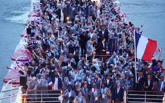 PARIS, FRANCE - JULY 26: Florent Manaudou and Melina Robert-Michon, Flagbearers of Team France, cruise on the River Seine during the athletes' parade during the opening ceremony of the Olympic Games Paris 2024 on July 26, 2024 in Paris, France. (Photo by Maddie Meyer / POOL / AFP) (Photo by MADDIE MEYER/POOL/AFP via Getty Images)