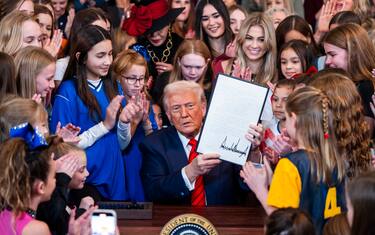 epaselect epa11877758 US President Donald Trump (C), surrounded by young female athletes, signs an executive order banning transgender athletes from women s sports, in the East Room of the White House in Washington, DC, USA, 05 February 2025. President Trump called the order titled 'Keeping Men Out of Women's Sports, a 'common sense'.  EPA/JIM LO SCALZO