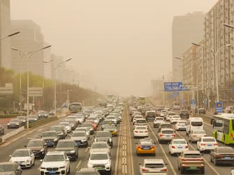 BEIJING, CHINA - MARCH 22: Vehicles are driven along a road during a sandstorm on March 22, 2023 in Beijing, China. (Photo by Song Yu/VCG via Getty Images)