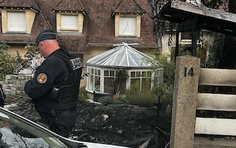 TOPSHOT - Municipal police officers stand in front of the damaged home of the Mayor of l'Hay-les-Roses Vincent Jeanbrun, in l'Hay-les-Roses, a suburb of Paris on July 2, 2023, after rioters rammed a vehicle into the building injuring the Mayor's wife and one of his children overnight, during continued disturbances across France after a 17-year-old man was killed by police in Nanterre, a western suburb of Paris on June 27. Rioters in France rammed a car into the home of the mayor of a town south of Paris, injuring his wife and one of his children, the mayor said July 2, 2023. (Photo by Nassim GOMRI / AFP) (Photo by NASSIM GOMRI/AFP via Getty Images)
