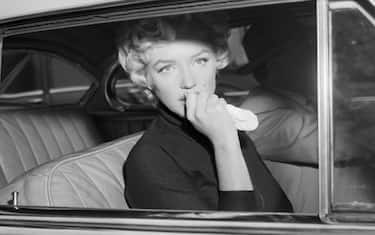 Marilyn Monroe leaves the home she briefly shared with Joe Di Maggio in a car driven by her attorney, Jerry Giesler. Monroe had just announced her intent to divorce Di Maggio on grounds of "mental cruelty"