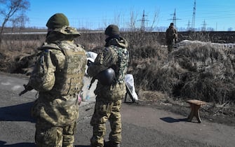 epa09845175 Ukrainian soldiers patrol the road near Kharkiv, Ukraine, 23 March 2022. On 24 February Russian troops had entered Ukrainian territory in what the Russian president declared a 'special military operation', resulting in fighting and destruction in the country, a huge flow of refugees, and multiple sanctions against Russia.  EPA/Andrzej Lange POLAND OUT