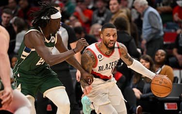 PORTLAND, OREGON - FEBRUARY 06: Damian Lillard #0 of the Portland Trail Blazers dribbles against Jrue Holiday #21 of the Milwaukee Bucks during the third quarter at the Moda Center on February 06, 2023 in Portland, Oregon. The Milwaukee Bucks won 127-108. NOTE TO USER: User expressly acknowledges and agrees that, by downloading and or using this photograph, User is consenting to the terms and conditions of the Getty Images License Agreement. (Photo by Alika Jenner/Getty Images)
