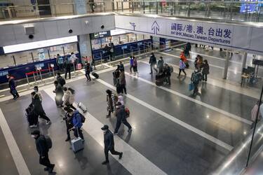 epa10394886 People walk inside the Beijing Capital International Airport in Beijing, China, 08 January 2023. China has reopened its borders and no longer requires quarantine for inbound travelers. The country's National Health Commission (NHC) has downgraded the management of COVID-19 from Class A to Class B as part of measures in reopening the country.  EPA/MARK R. CRISTINO