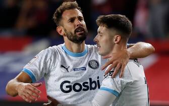 epa11022259 Girona's midfielder Valery Fernandez (R) jubilates with his teammate Uruguayan striker Cristhian Stuani after scoring the 1-3 lead during the Spanish LaLiga soccer match between FC Barcelona and Girona FC at Estadio Olimpico Lluis Companys stadium in Barcelona, Catalonia, Spain, 10 December 2023.  EPA/Andreu Dalmau