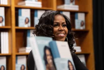 Former US first lady Michelle Obama meets with fans during a book signing on the first anniversary of the launch of her memoir "Becoming" at the Politics and Prose bookstore in Washington, DC, on November 18, 2019. (Photo by NICHOLAS KAMM / AFP) (Photo by NICHOLAS KAMM/AFP via Getty Images)