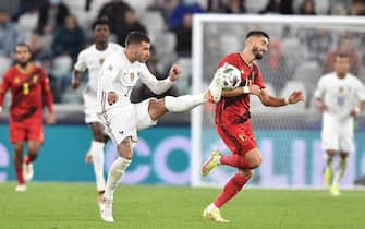 epa09512126 Yannick Carrasco of Belgium in action against Lucas Hernandez of France during the UEFA Nations League semi final soccer match between Belgium and France in Turin, Italy, 07 October 2021.  EPA/Alessandro di Marco