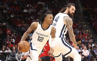 HOUSTON, TEXAS - MARCH 06: Ja Morant #12 of the Memphis Grizzlies receives a pick from Steven Adams #4 as he drives to the basket against the Houston Rockets at Toyota Center on March 06, 2022 in Houston, Texas.  NOTE TO USER: User expressly acknowledges and agrees that, by downloading and or using this photograph, User is consenting to the terms and conditions of the Getty Images License Agreement (Photo by Bob Levey/Getty Images)