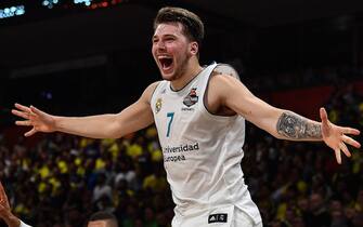 Real Madrid's Slovenian Luka Doncic (C-7) jumps over the barrier as the team celebrates their 85-80 win over Fenerbahce in the Euroleague Final Four finals basketball match between Real Madrid and Fenerbahce Dogus Istanbul at The Stark Arena in Belgrade on May 20, 2018. (Photo by Andrej ISAKOVIC / AFP)        (Photo credit should read ANDREJ ISAKOVIC/AFP via Getty Images)