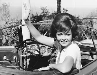 Actress Sandra Milo waving from her car in a scene from the film 'The Big Parasol', Rome, October 1965. (Photo by Keystone/Hulton Archive/Getty Images)