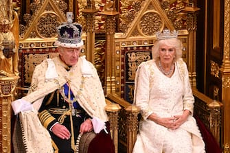 Britain's King Charles III, wearing the Imperial State Crown and the Robe of State, and Britain's Queen Camilla, wearing the George IV State Diadem, sits on The Sovereign's Throne in the House of Lords chamber, during the State Opening of Parliament, at the Houses of Parliament, in London, on November 7, 2023. (Photo by Leon Neal / POOL / AFP)