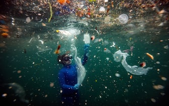 ISTANBUL, TURKEY - JUNE 27: Turkish world record-holder free-diver and divers of the Underwater Federation Sahika Encumen dives amid plastic waste in Ortakoy coastline to observe the life and pollution of Bosphorus in Istanbul, Turkey on June 27, 2020. Sahika Encumen, announced as âLife Below Water Advocateâ  by United Nations Development Program (UNDP) Turkey, this time dives in to raise awareness on plastic pollution. (Photo by Sebnem Coskun/Anadolu Agency via Getty Images)