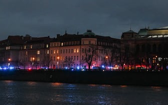 The flashing lights from emergency vehicles are seen along the bank of river Moldau by the Charles University in central Prague, on December 21, 2023. Czech police said a shooting in a university building in central Prague has left "dead and wounded people", without providing further details.
"Based on the initial information we have, we can confirm dead and wounded people on the scene," police said on X, formerly Twitter. Czech media said the shooting had occurred at the Faculty of Arts whose teachers and students were instructed to lock themselves up as the police action was under way. (Photo by Michal CIZEK / AFP) (Photo by MICHAL CIZEK/AFP via Getty Images)