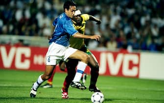 17 Jun 1998:  Alessandro Nesta of Italy holds off Patrick Mboma of Cameroon during the World Cup group B game at the Stade de la Mosson in Montpellier, France. Italy won 3-0. \ Mandatory Credit: Stu Forster /Allsport