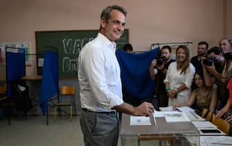 Greek Prime Minister and leader of New Democracy Conservative Party Kyriakos Mitsotakis votes during the European elections in Athens on June 9, 2024. Voting began across Europe on June 9, 2024 on the final -- and biggest -- day of marathon EU elections, with balloting due in 21 countries, including France and Germany, where support for surging far-right parties is being tested. (Photo by Aris MESSINIS / AFP)