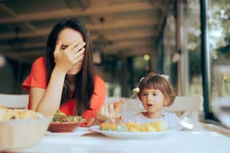Disobedient toddler girl being fussy about food