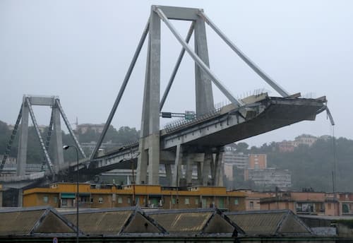 A picture taken on August 14, 2018 in Genoa shows a view of the Ponte Morandi motorway bridge, after one of its section collapsed injuring several people. - Rescuers scouring through the wreckage after part of a viaduct of the A10 freeway collapsed said there were "tens of victims", while images from the scene showed an entire carriageway plunged on to railway lines below. (Photo by ANDREA LEONI / AFP)        (Photo credit should read ANDREA LEONI/AFP via Getty Images)