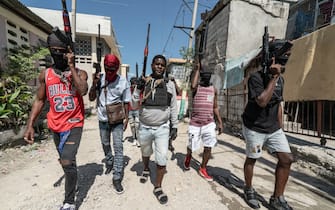 Jimmy "Barbecue" Chérizier (center) is a Haitian gang leader and a former police officer who is the head of the G9 gang federation which consists of over a dozen Haitian gangs based in Port au Prince. Chérizier is currently considered the most powerful gang leader in Haiti today.