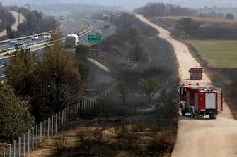 epa10811522 General view of a burnt area near Egnatia Odos motorway, in Alexandroupolis, Thrace, northern Greece, 21 August 2023. The wildfire that broke out early on 19 August in a forest in the Melia area of Alexandroupolis has spread rapidly due to the strong winds blowing in the area and is raging uncontrolled.The major wildfire in Alexandroupolis continues with unabated intensity for the third consecutive day. According to the Fire Department, the fire is difficult to be contained due to the strong winds in the area.  EPA/ALEXANDROS BELTES