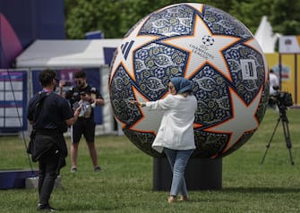 epa10679815 A woman poses with a huge model ball of UEFA Champions League during the UEFA Champions Festival at the Yenikapi event area in Istanbul, Turkey, 08 June 2023. Manchester City will play Inter Milan in the UEFA Champions League final at the Ataturk Olympic Stadium in Istanbul on 10 June 2023.  EPA/ERDEM SAHIN