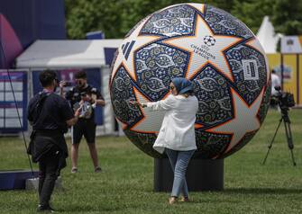 epa10679815 A woman poses with a huge model ball of UEFA Champions League during the UEFA Champions Festival at the Yenikapi event area in Istanbul, Turkey, 08 June 2023. Manchester City will play Inter Milan in the UEFA Champions League final at the Ataturk Olympic Stadium in Istanbul on 10 June 2023.  EPA/ERDEM SAHIN