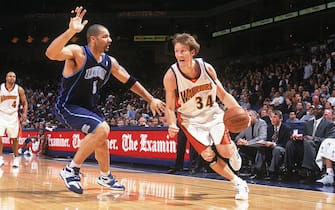 OAKLAND, CA - NOVEMBER 5:  Mike Dunleavy Jr #34 of the Golden State Warriors drives around Carlos Boozer #5 of the Utah Jazz during a game at The Arena in Oakland on November 5, 2004 in Oakland, California.  The Jazz won 102-80. NOTE TO USER: User expressly acknowledges and agrees that, by downloading and/or using this Photograph, user is consenting to the terms and conditions of the Getty Images License Agreement. Mandatory Copyright Notice: Copyright 2004 NBAE (Photo by Rocky Widner/NBAE via Getty Images)