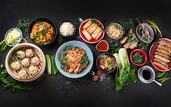 Assorted Chinese food on dark background. Asian food concept. Top view