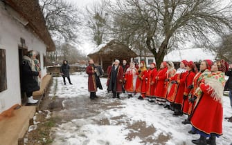 epa11044021 Ukrainians wearing traditional attire sing Christmas carols as they walk from house to house in Pyrogovo village, near Kyiv (Kiev), Ukraine, 25 December 2023, amid the Russian invasion. Ukraine celebrates Christmas on 25 December for the first time this year, in accordance with the Western calendar. Ukrainian President Zelensky signed a law in July to move the official Christmas Day holiday to 25 December, departing from the Russian Orthodox Church tradition of celebrating on 07 January. Russian troops entered Ukraine on 24 February 2022 starting a conflict that has provoked destruction and a humanitarian crisis.  EPA/SERGEY DOLZHENKO