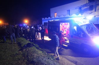 Rescuers assist injured people outside the nightclub 'Lanterna Azzurra' in Corinaldo, near Ancona, central Italy, 08 December 2018. A stampede that occurred overnight outside the nightclub killed six people and injured more than 100, after someone probably caused a panic with a stinging spray. The incident took place at the packed club hosting a concert by popular Italian rapper Sfera Ebbasta. ANSA/ STRINGER