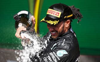 AUTÃ³DROMO JOSÃ© CARLOS PACE, BRAZIL - NOVEMBER 14: Sir Lewis Hamilton, Mercedes, 1st position, celebrates with Champagne during the Brazilian GP at AutÃ³dromo JosÃ© Carlos Pace on Sunday November 14, 2021 in Sao Paulo, Brazil. (Photo by Charles Coates / LAT Images)