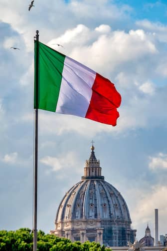 Italian flag and the dome of Saint Peter