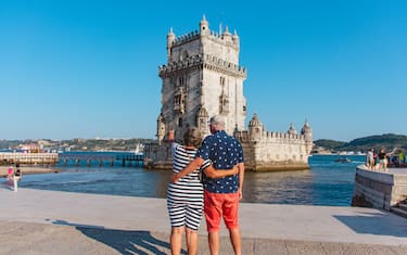 Senior couple bonding in front of Belem Tower, Lisbon, Portugal