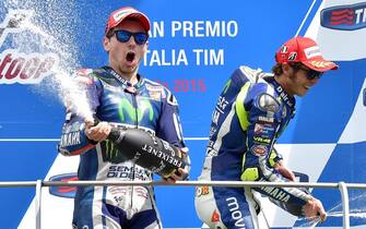 Spanish MotoGP rider Jorge Lorenzo (L) of the Movistar Yamaha team celebrates on the podium after winning the Grand Prix of Italy at the Mugello circuit, Scarperia, central Italy, 31 May 2015. Italian MotoGP rider Andrea Iannone of the Ducati Team took the second place ahead of Italian MotoGP rider Valentino Rossi (R) of the Movistar Yamaha team.    ANSA/ETTORE FERRARI







