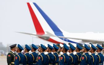 The plane of French President Emmanuel Macron taxis after landing as members of the Chinese guard of honour prepare for his arrival at Beijing Capital International Airport in Beijing on April 5, 2023. (Photo by GONZALO FUENTES / POOL / AFP) (Photo by GONZALO FUENTES/POOL/AFP via Getty Images)