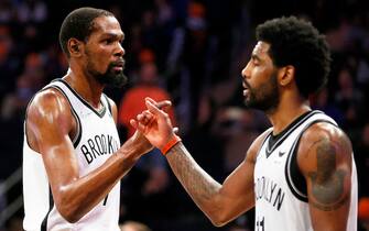 NEW YORK, NEW YORK - APRIL 06: Kevin Durant #7 and Kyrie Irving #11 of the Brooklyn Nets react during the second half against the New York Knicks at Madison Square Garden on April 06, 2022 in New York City. The Nets won 110-98. NOTE TO USER: User expressly acknowledges and agrees that, by downloading and or using this photograph, User is consenting to the terms and conditions of the Getty Images License Agreement.  (Photo by Sarah Stier/Getty Images)