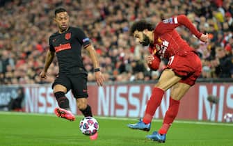 epa08287335 Mohamed Salah (R) of Liverpool in action against Renan Lodi of Atletico during the UEFA Champions League Round of 16, second leg match between Liverpool FC and Atletico Madrid in Liverpool, Britain, 11 March 2020.  EPA/PETER POWELL